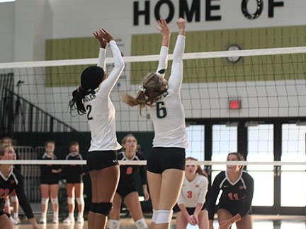 Seniors Lauren Radalia and  MyAzia West go up for a block against Hoover.