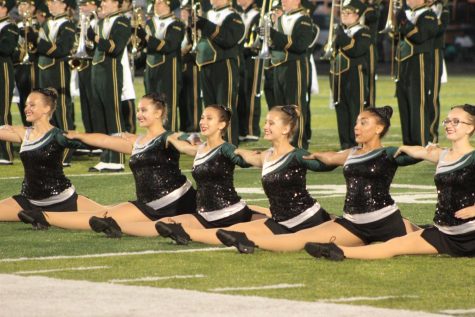Members of the color guard perform at the first home football game in August.  This was the first year many members performed in front of an audience. Photo by Kaia Kimble