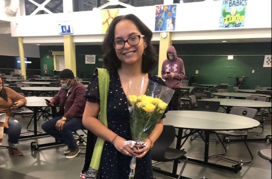 Image+of+Lizbeth+Cisneros+holding+flowers+at+a+community+event.+Lizbeth+learned+both+Spanish+and+English+at+the+same+time+.