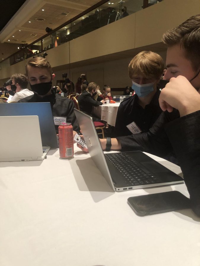 OMUN members Andy Martens, Bradley Mull, and Brody Fravel looking at opposing resolutions.