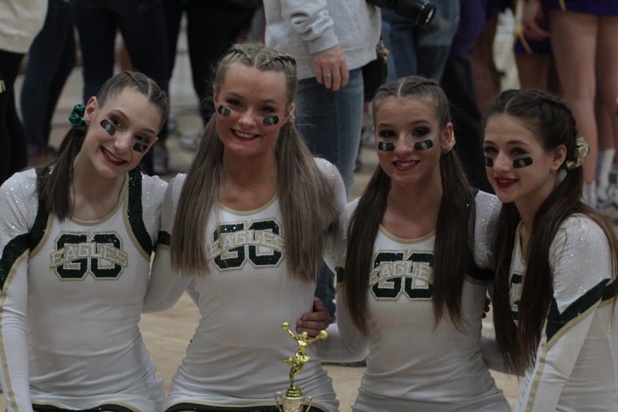 Seniors Madelyn Eash, Jenna Simmons, Ella Tyler and Olivia Welch pose for a picture at the end of competition in December.  The cheerleaders qualified for states four times in the past four years. 