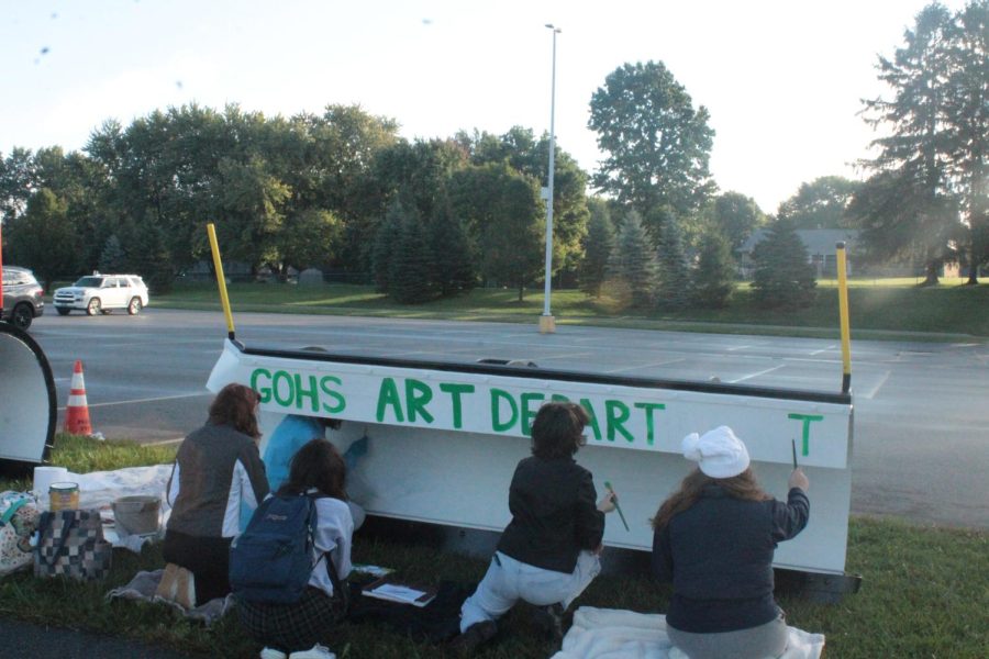  Students Addi Postlewaite, Bella Lattavo and Olivia Crowl paint Crowl’s sketch on the snow plow with the help of IB visual arts students.“We wanted to make sure everyone knew we did this,”student Olivia Crowl said.