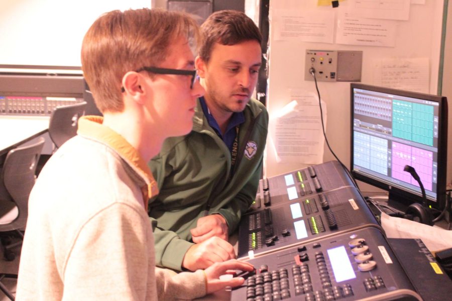 Anthony Depinto works with senior Tyler Hoffman in the light and sound booth.