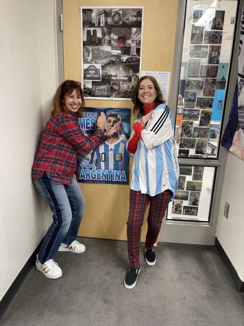 Teacher Julie Filliez and Silvia Molina pose in front of Filliezs door that Molina had decorated with a Messi poster.  The teachers rooted for the opposite teams during the World Cup and formed a friendly rivalry.