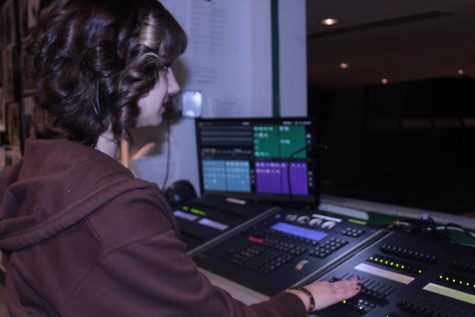 Sophomore Intro to Light and Sound student Cora Bankert works behind the scenes at a rehearsal. I like doing the lighting because it can help set the mood and its really important in any production, Bankert said.
