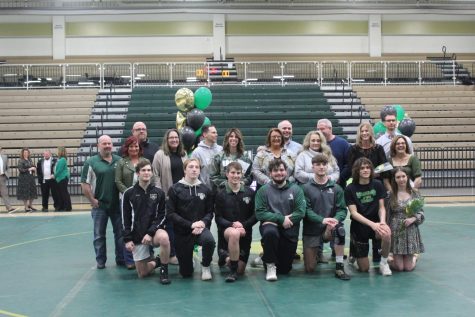 Senior wrestling team members with their families on senior night. Photo by Lily Hoza