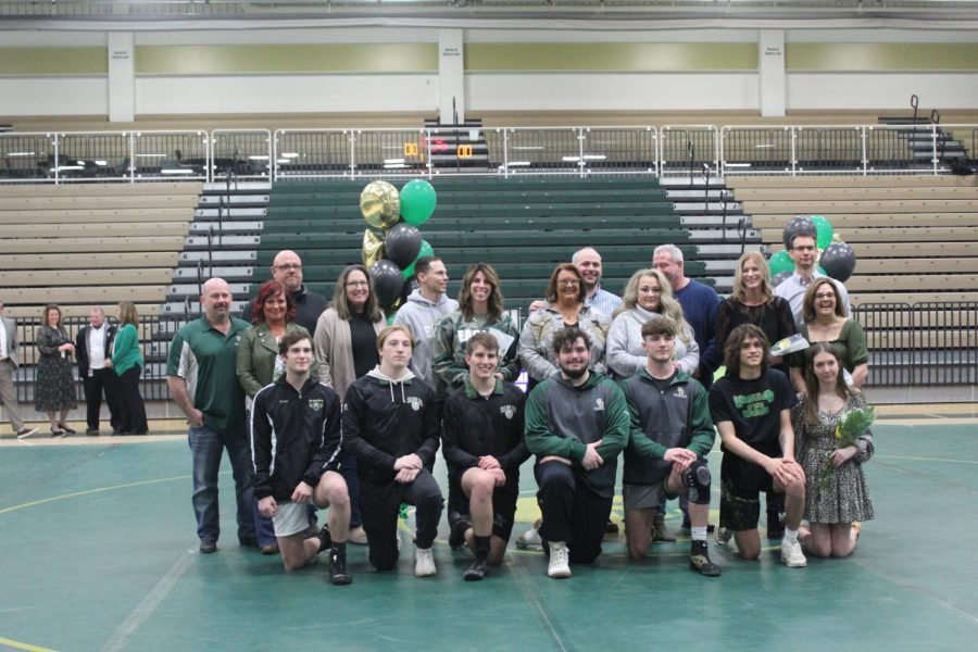 Senior+wrestling+team+members+with+their+families+on+senior+night.+Photo+by+Lily+Hoza