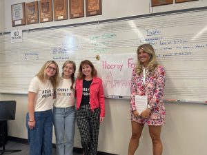 Anna Kloots poses with a sign made for her by French classes. 