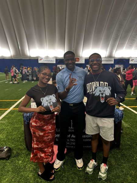 Seniors AMyila Campbell and Malcolm Morgan pose with a representative from an HBCU school during the Pro Football Hall of Fame College fair. 