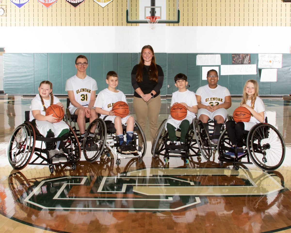 The wheelchair basketball ball team members...I NEED THEIR NAMES pose for a group shot.