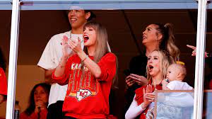 Taylor Swift shown on TV during a Chiefs game, cheering for her baby boo Travis Kelce.