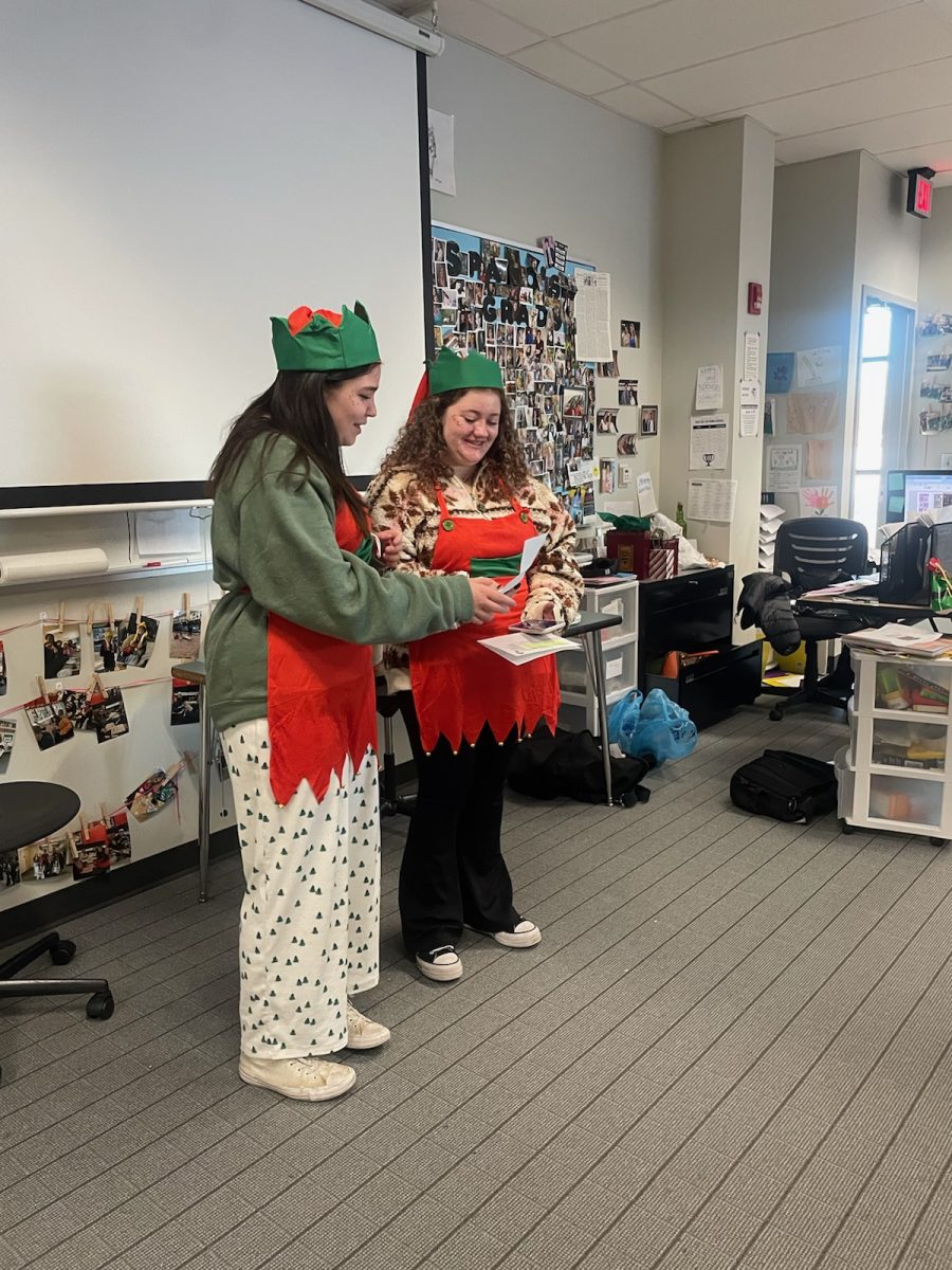 Ava Motz and Ruby Shaheen deliver an Elf Gram on the last day of school before break. 