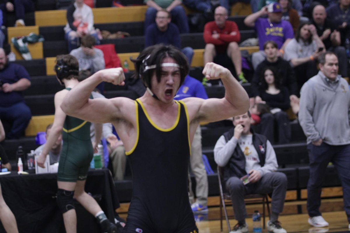 Celebrating Victory: Leu flexes after he realizes that he has won the match and qualified for state.
