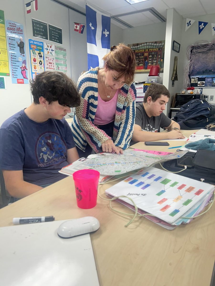 French teacher Julie Filliez and sophomore Patrick Arway look at a map of Paris