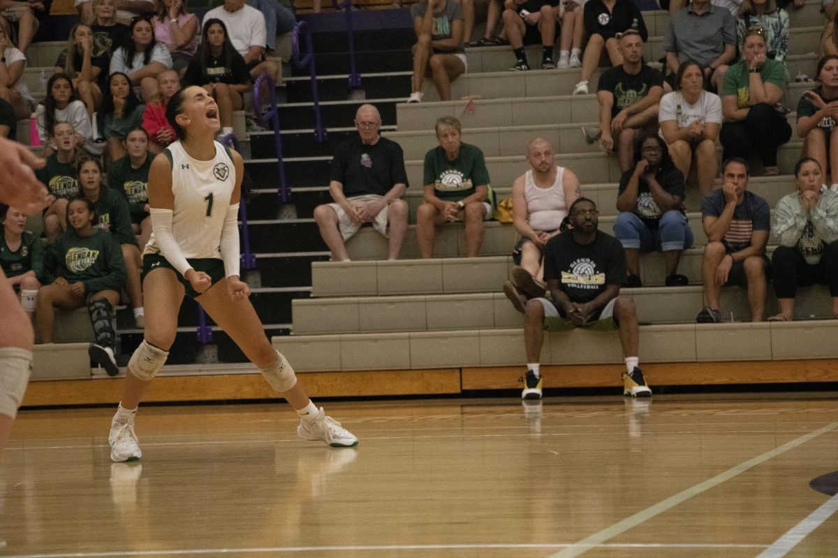 Senior Mackenzie Ging celebrates after scoring a point against Jackson.