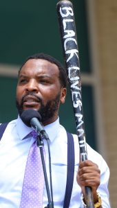 FeaturingDallas, CC0, via Wikimedia Commons

Civil Rights Attorney Lee Merrit holding a Black Lives Matter bat speaking at the National Day of Mourning for Sonya Massey in Dallas, Texas on Sunday July 28, 2024