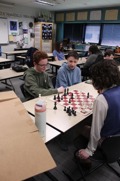 Nathan Tolin, Ben Martens, and Liana Orn particpate in a match of chess last year.  Chess club meets every Wed.  This year members plan to attend a chess tournament. 