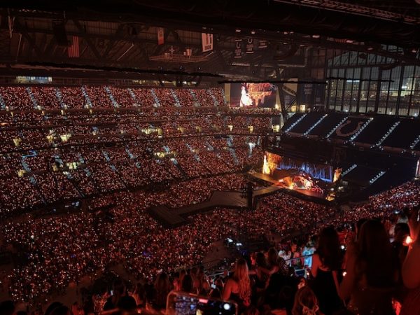 The crowd inside the stadium during Taylor's "Folklore" and "Evermore" eras, lit up with LED bracelets worn by fans