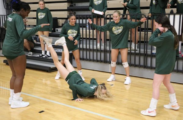 JV teammates Lydia Suba, Charlotte Ayers, Isabella Tilleni, Lucy Garver and MyMy Lipkins cheer on Maddy Potter as she does "the worm" in between sets.