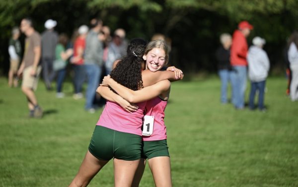 Senior Kate Kaplanis and junior Amina Salem right before their last cross country race together.