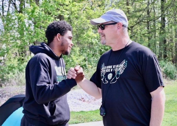 Track coach Scott Ferrell encourages a member of the track team last weekend at the Hudson Invitational. Ferrell is senior Sydney Stepanovich's inspiration.
