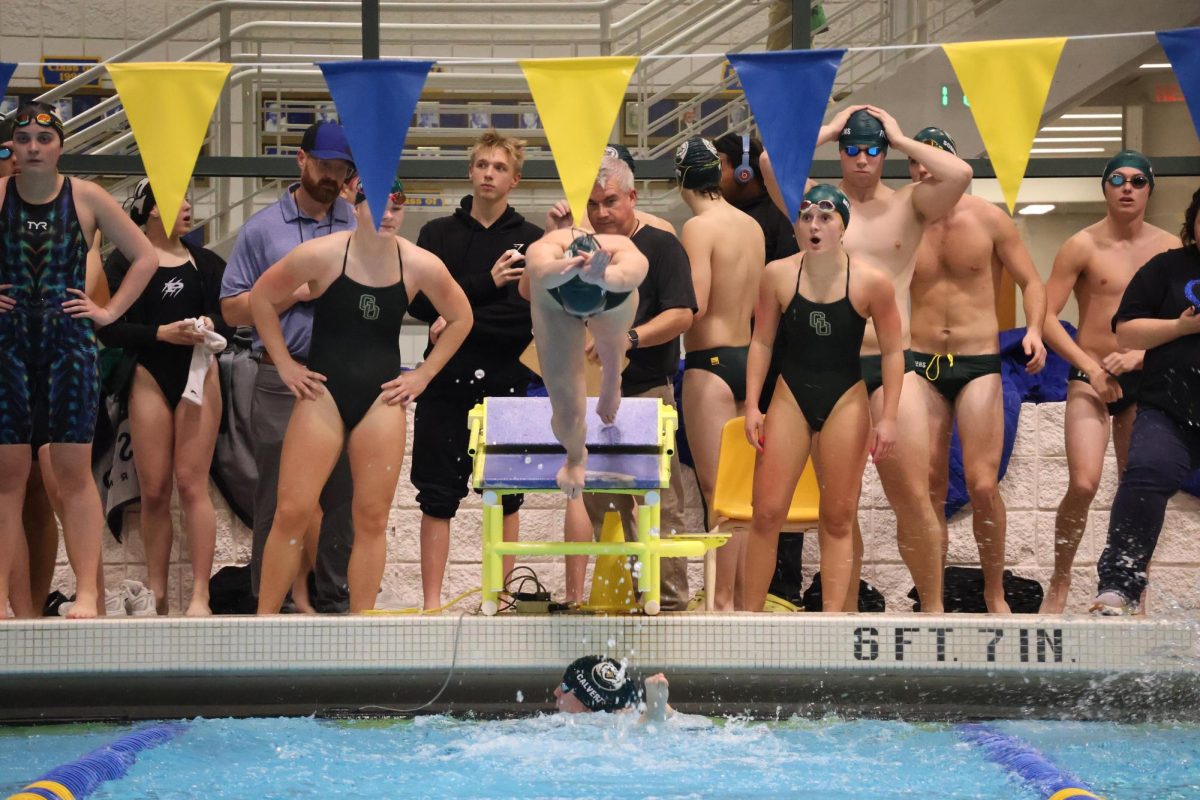Rowan Holliday dives into the pool at Wooster to swim her 50 of the 200 yard freestyle relay. 
