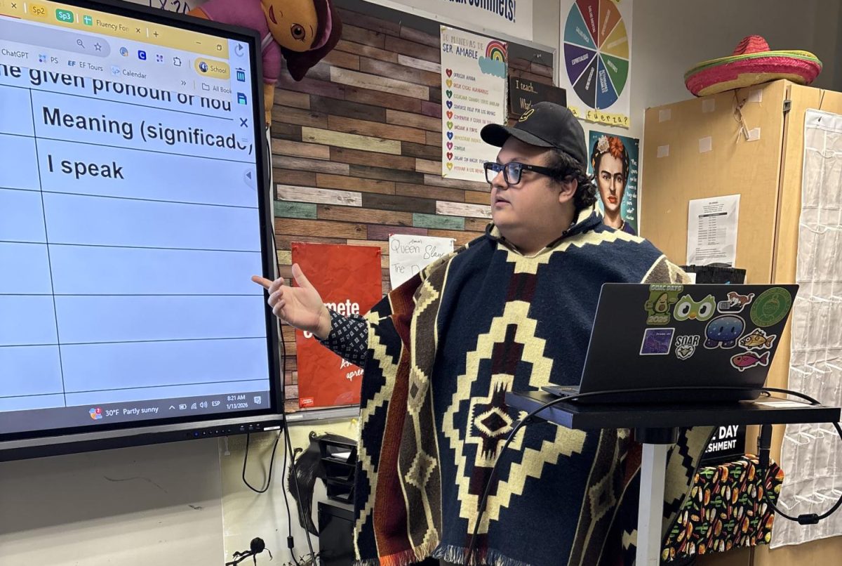 Spanish teacher Tyler Smith teaches verbs to his Spanish I class. 