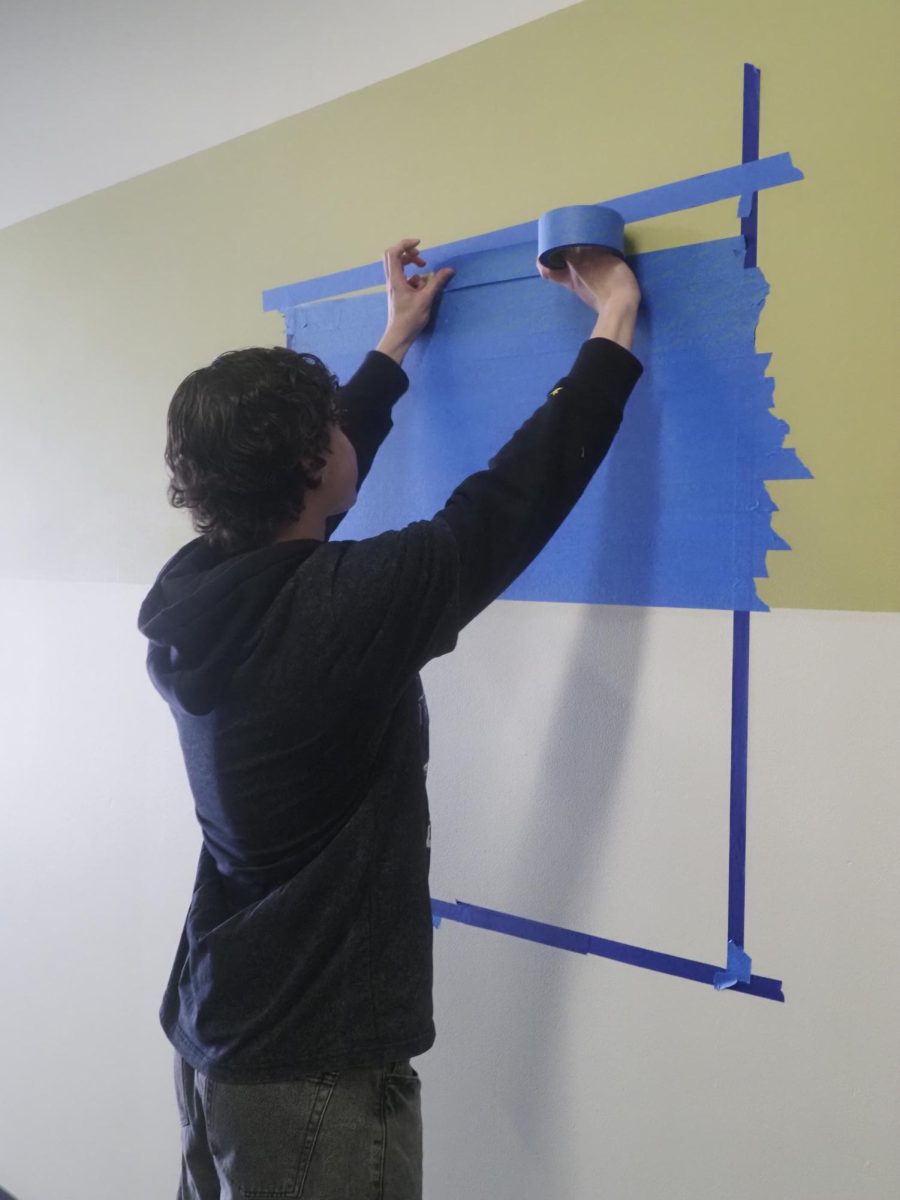 Students in art teacher Jill Balderson's class work on their tape mural. 