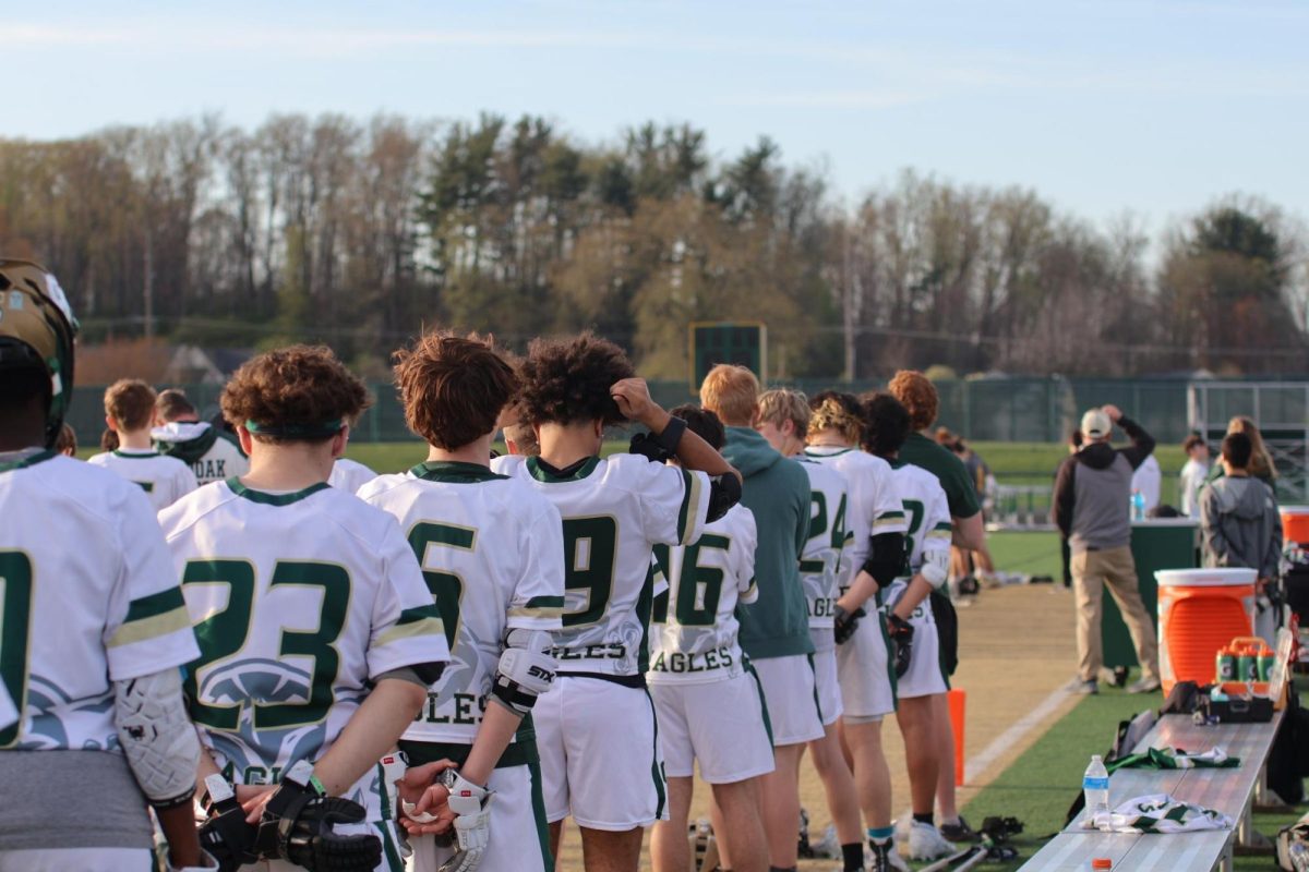 Members of the 2025 boys lacrossesse team stand for the National Anthem.