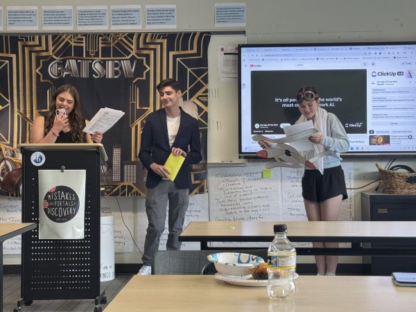 Juniors McVehil Bell, Jimmy Zurbach, Madi Alvond act out a skit in IB English after reading The Great Gatsby. The students dressed up as people from the 1920s who woulb be at a Gatsby party.