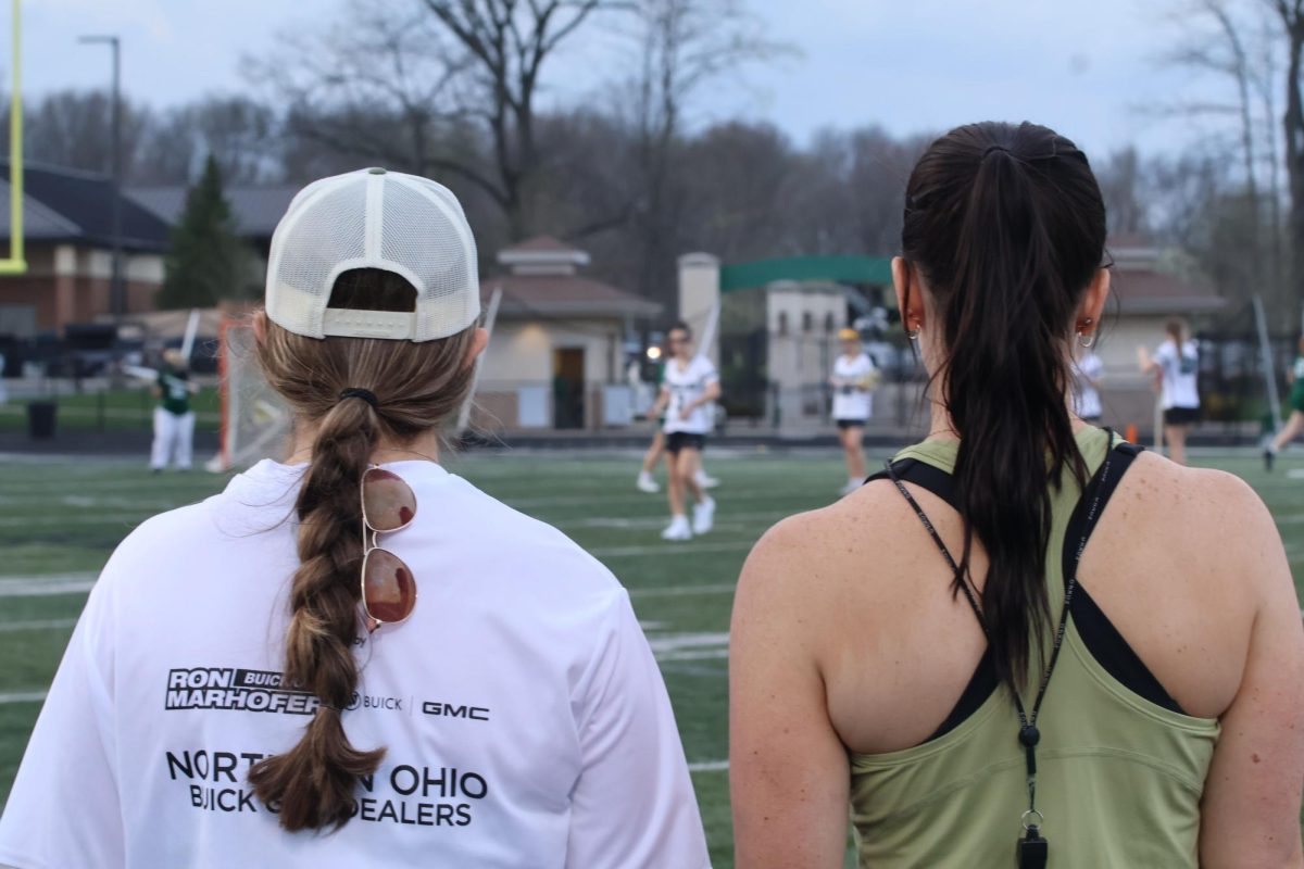 Coaches Abigail May and Megan Rea during a girls lacrosse match this season. May is a recent addition to the coaching staff. 