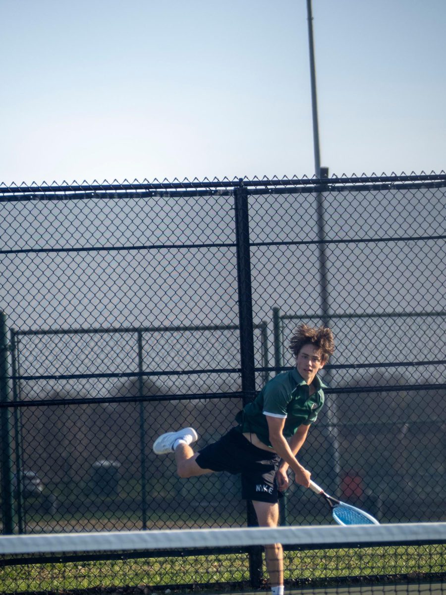 Sophomore Luke Johnston returns a ball during a match in April.  