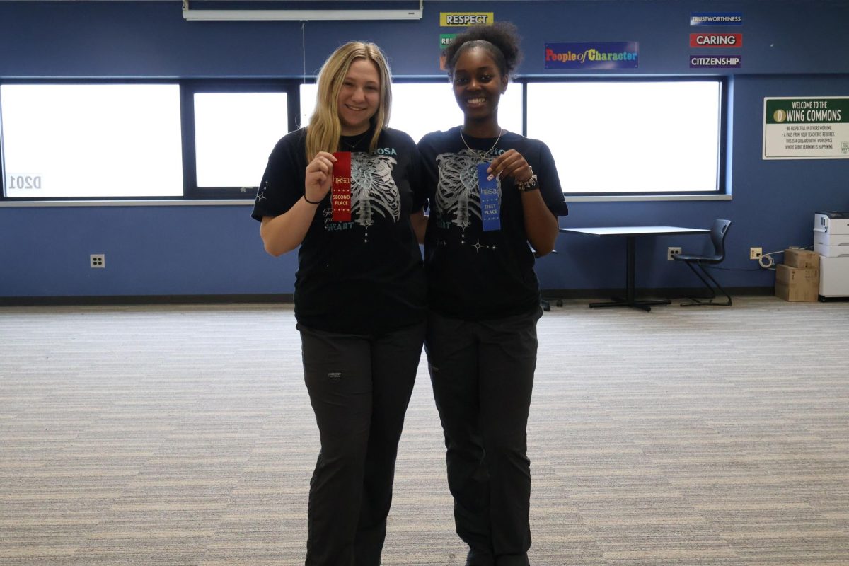 Junior Morgan Stauffer and Kalia Hooks show off their ribbons from HOSA's regional competition.  At States, Hooks placed first, and Stauffer placed third. 